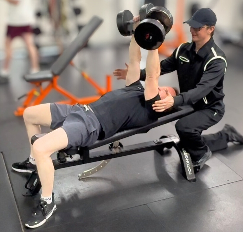 Coach Donovan working with a 50-year-old male client in the gym.
